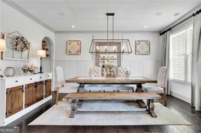 3330 Riverwalk Way, Cumming, GA 30040 - dining space with arched walkways, wainscoting, dark wood-style floors, crown molding, and a chandelier