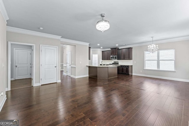 350 Paces Dr, Lithia Springs, GA 30122 - unfurnished living room with a chandelier, baseboards, dark wood finished floors, recessed lighting, and ornamental molding