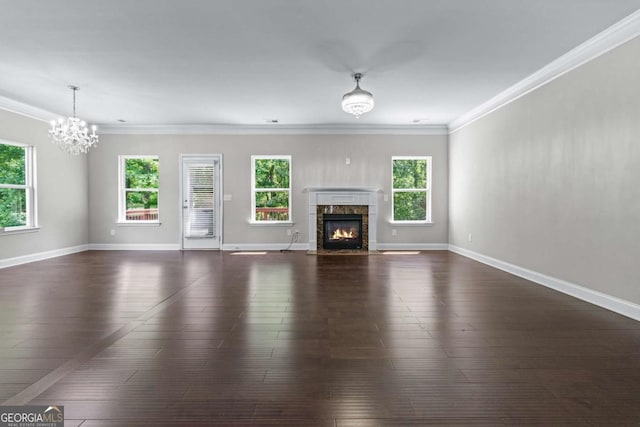 350 Paces Dr, Lithia Springs, GA 30122 - unfurnished living room featuring a chandelier, a premium fireplace, ornamental molding, dark wood finished floors, and baseboards