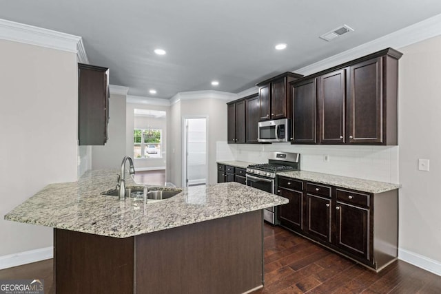350 Paces Dr, Lithia Springs, GA 30122 - kitchen with appliances with stainless steel finishes, a sink, ornamental molding, dark brown cabinetry, and baseboards