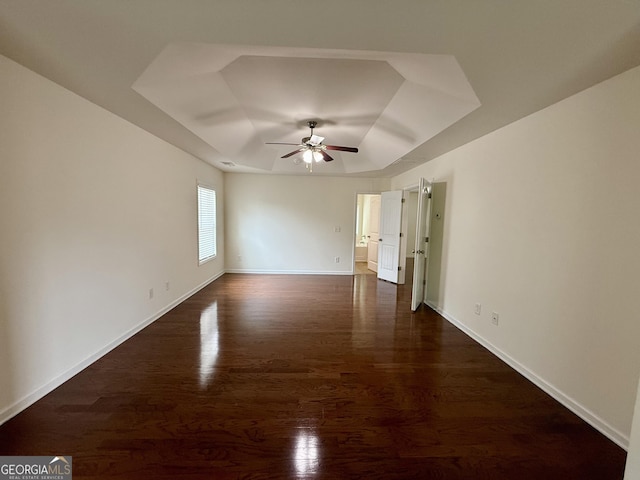 3389 Rosecliff Trce, Buford, GA 30519 - unfurnished room with a tray ceiling, a ceiling fan, dark wood-style flooring, and baseboards
