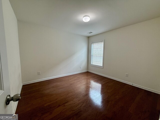 3389 Rosecliff Trce, Buford, GA 30519 - empty room featuring dark wood-type flooring and baseboards