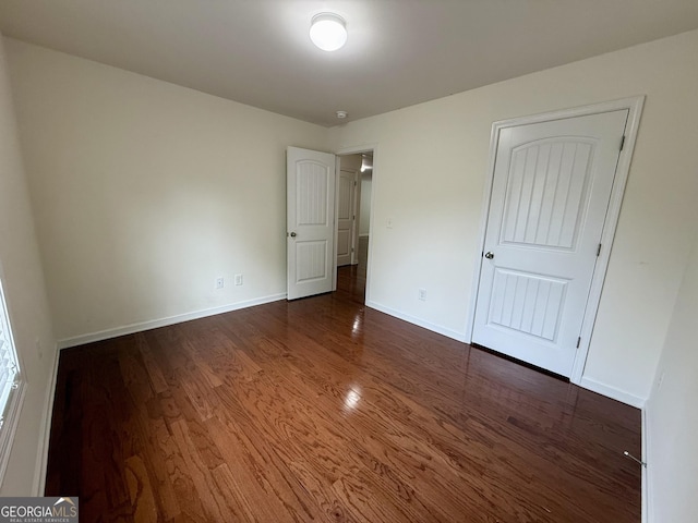 3389 Rosecliff Trce, Buford, GA 30519 - unfurnished bedroom with dark wood finished floors and baseboards