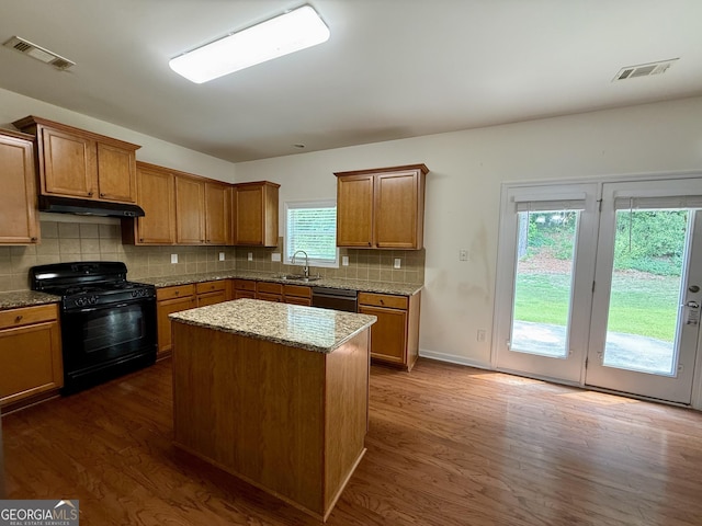 3389 Rosecliff Trce, Buford, GA 30519 - kitchen featuring black gas range, dishwasher, dark wood-type flooring, and brown cabinets