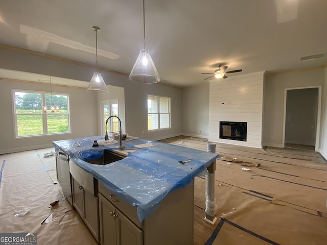 179 Merwood Ln Unit 125, Jefferson, GA 30549 - kitchen featuring stainless steel dishwasher, a ceiling fan, open floor plan, a center island with sink, and crown molding