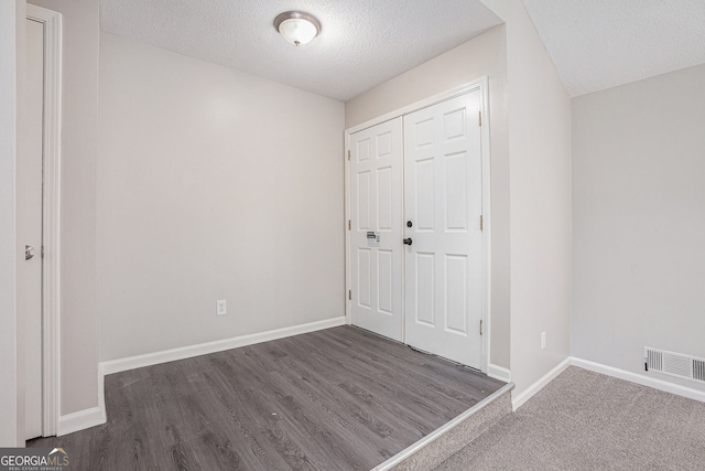 3006 Alberta Dr, Marietta, GA 30062 - unfurnished bedroom featuring a textured ceiling, baseboards, wood finished floors, and a closet