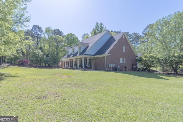 11389 Whitesville Rd, Fortson, GA 31808 - view of property exterior with a lawn, brick siding, and central AC unit