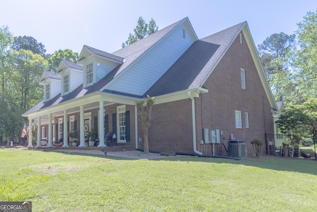 11389 Whitesville Rd, Fortson, GA 31808 - view of property exterior featuring central air condition unit, brick siding, covered porch, and a lawn