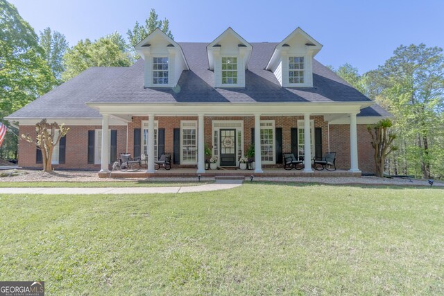 11389 Whitesville Rd, Fortson, GA 31808 - view of front of house with a front lawn, brick siding, covered porch, and roof with shingles