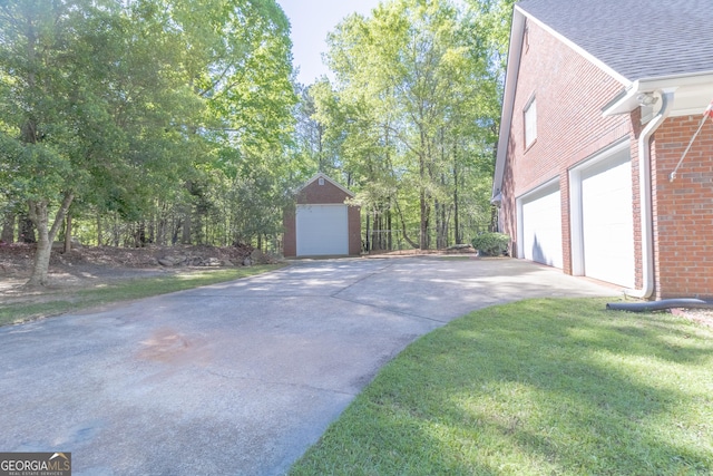 11389 Whitesville Rd, Fortson, GA 31808 - view of property exterior with brick siding, a shingled roof, driveway, and a garage