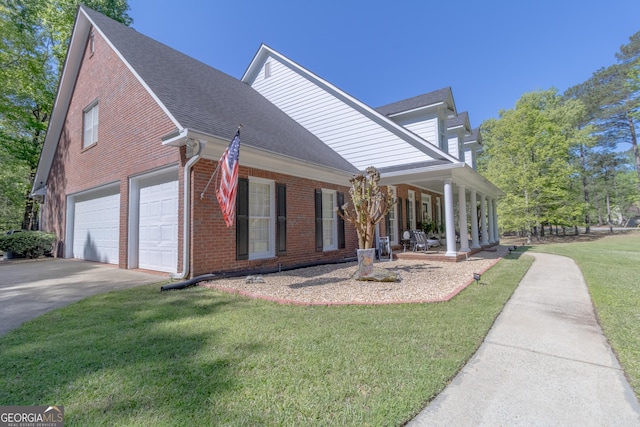 11389 Whitesville Rd, Fortson, GA 31808 - view of side of home with brick siding, covered porch, concrete driveway, a lawn, and a shingled roof