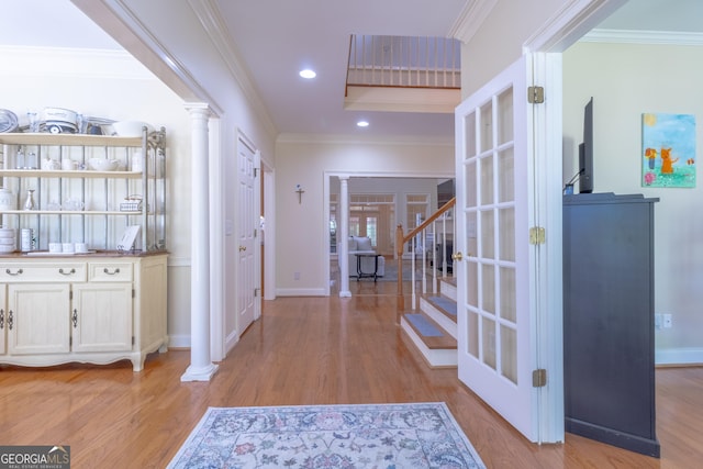 11389 Whitesville Rd, Fortson, GA 31808 - hall with ornate columns, light wood-style floors, stairs, ornamental molding, and baseboards
