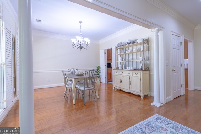 11389 Whitesville Rd, Fortson, GA 31808 - dining room with ornamental molding, a chandelier, light wood-style floors, baseboards, and ornate columns