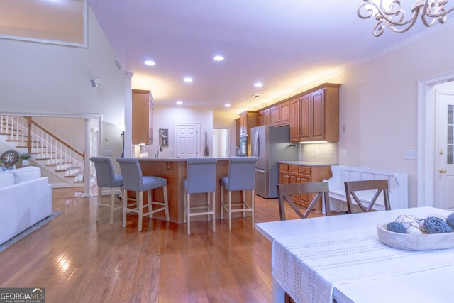 11389 Whitesville Rd, Fortson, GA 31808 - dining space featuring stairs, light wood-type flooring, recessed lighting, crown molding, and a chandelier