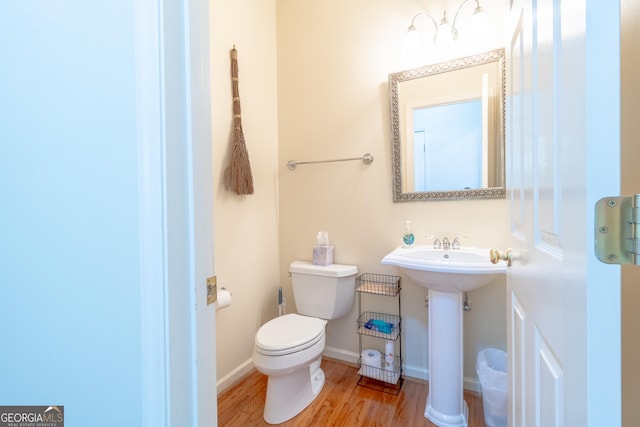 11389 Whitesville Rd, Fortson, GA 31808 - half bath with toilet, wood finished floors, baseboards, and a sink