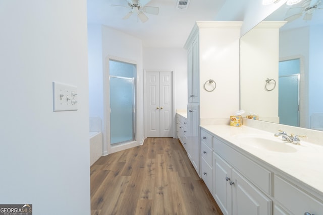 11389 Whitesville Rd, Fortson, GA 31808 - bathroom featuring a ceiling fan, vanity, wood finished floors, and a stall shower