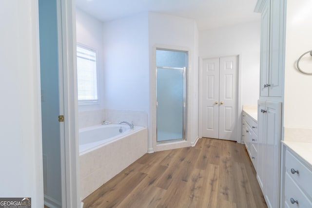 11389 Whitesville Rd, Fortson, GA 31808 - full bath featuring vanity, a stall shower, a bath, and wood finished floors