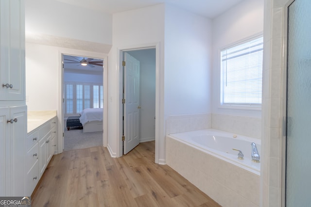 11389 Whitesville Rd, Fortson, GA 31808 - bathroom featuring wood finished floors, a bath, vanity, ceiling fan, and ensuite bathroom