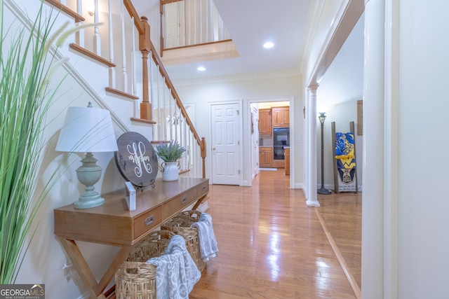 11389 Whitesville Rd, Fortson, GA 31808 - foyer with ornamental molding, ornate columns, stairway, light wood finished floors, and baseboards