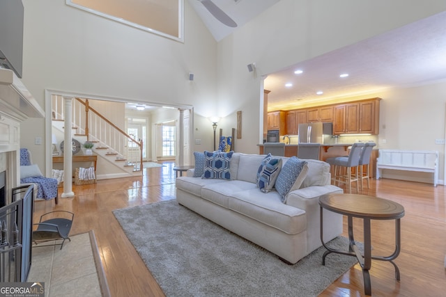 11389 Whitesville Rd, Fortson, GA 31808 - living room featuring light wood-style floors, stairway, a fireplace, and recessed lighting