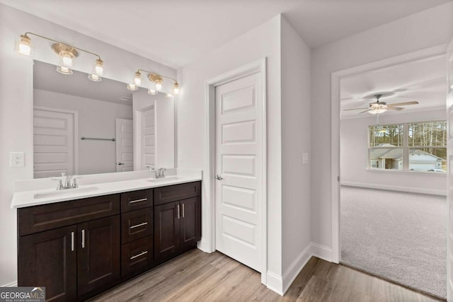 321 Magnolia Villas Dr, Cornelia, GA 30531 - full bathroom with double vanity, baseboards, wood finished floors, and ceiling fan