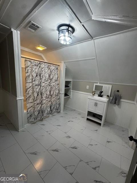 44 Lee St, Concord, GA 30206 - full bathroom featuring vanity, wainscoting, curtained shower, and marble look tiles