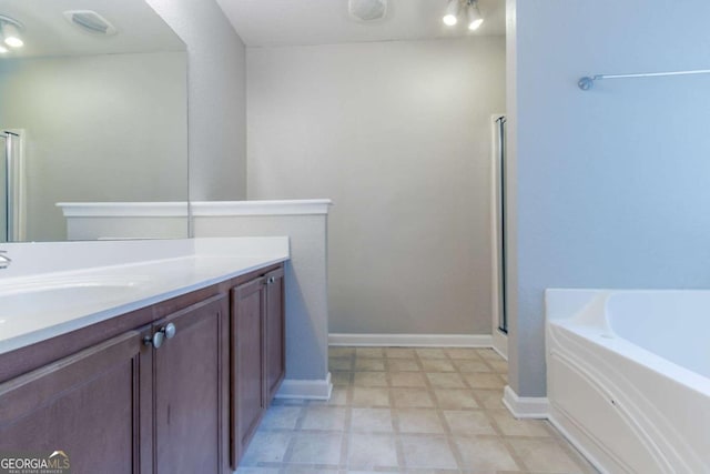 4695 Ravenwood Loop, Union City, GA 30291 - bathroom with vanity, a stall shower, a bath, baseboards, and tile patterned floors