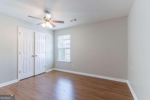 4695 Ravenwood Loop, Union City, GA 30291 - unfurnished bedroom with wood finished floors, baseboards, a closet, and ceiling fan