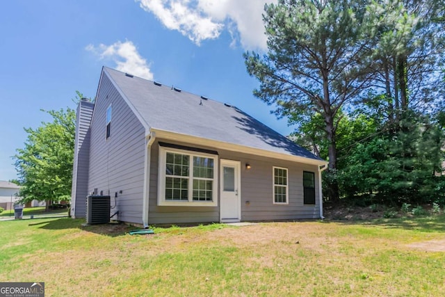 4695 Ravenwood Loop, Union City, GA 30291 - view of front of property featuring central AC, a front yard, and a chimney