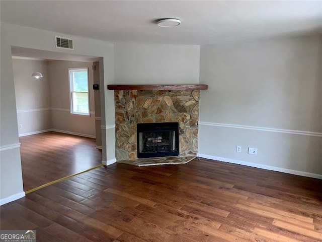 4347 Barrington Pl, Macon, GA 31210 - unfurnished living room featuring wood finished floors, baseboards, and a stone fireplace