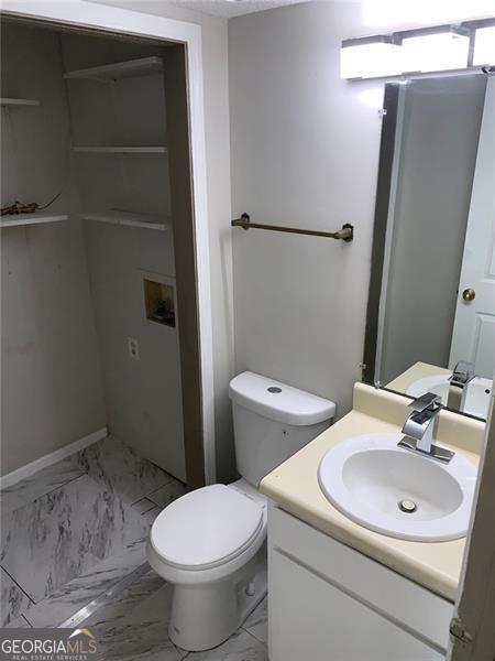 4347 Barrington Pl, Macon, GA 31210 - bathroom featuring marble finish floors, vanity, and toilet