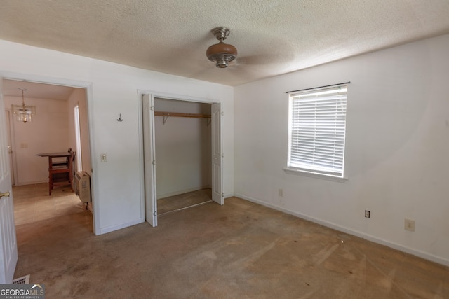 1385 Kinsey Town Rd, Cleveland, GA 30528 - unfurnished bedroom featuring carpet, baseboards, a closet, a textured ceiling, and a chandelier