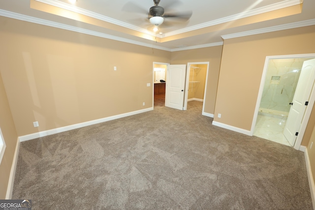 1663 Piedmont Rd, Griffin, GA 30224 - unfurnished bedroom featuring a raised ceiling, crown molding, carpet floors, a spacious closet, and baseboards