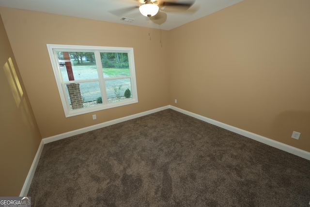 1663 Piedmont Rd, Griffin, GA 30224 - spare room with ceiling fan, dark colored carpet, and baseboards