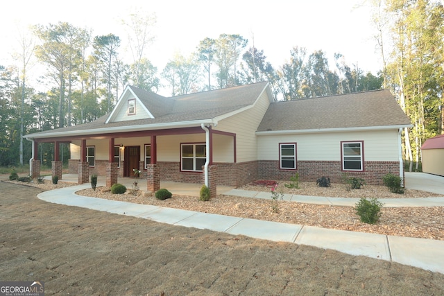 1663 Piedmont Rd, Griffin, GA 30224 - view of front of property featuring brick siding, a porch, and a shingled roof