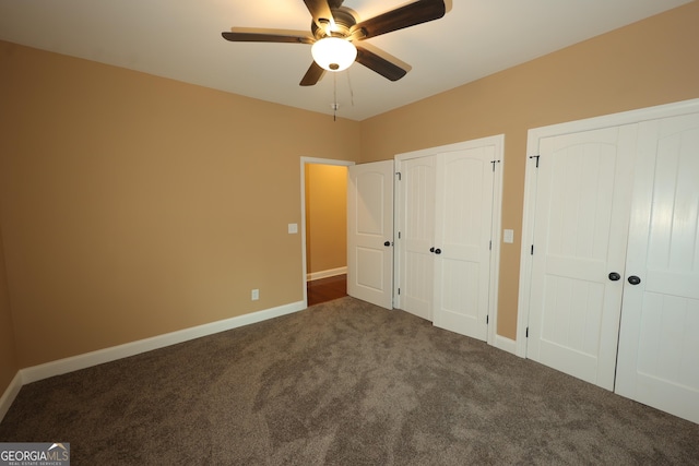 1663 Piedmont Rd, Griffin, GA 30224 - unfurnished bedroom featuring two closets, carpet flooring, baseboards, and ceiling fan