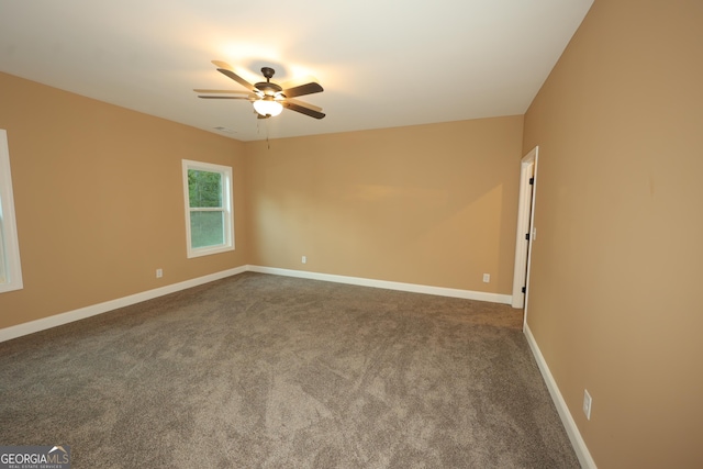 1663 Piedmont Rd, Griffin, GA 30224 - spare room featuring a ceiling fan, dark colored carpet, and baseboards