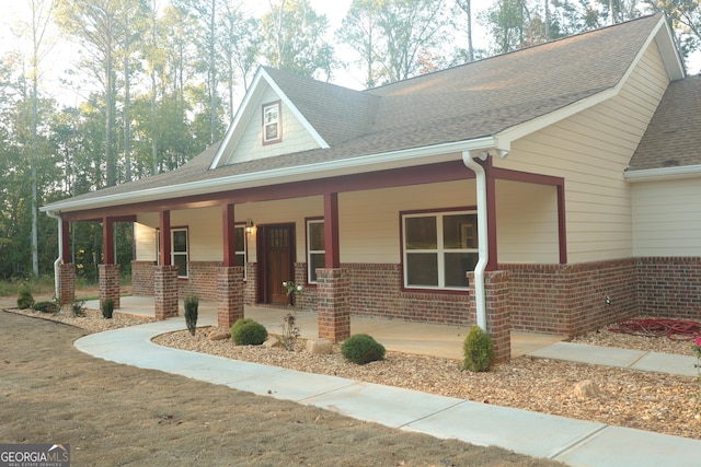 1663 Piedmont Rd, Griffin, GA 30224 - view of front facade with brick siding, covered porch, and a shingled roof