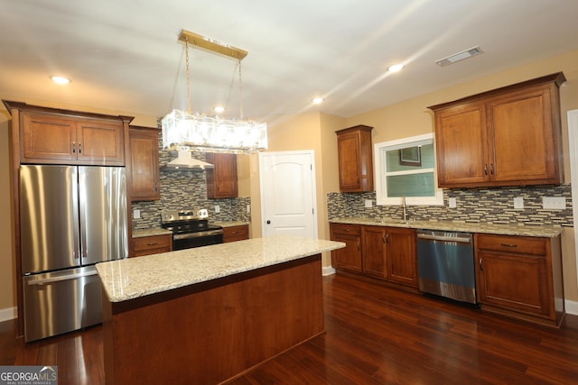 1663 Piedmont Rd, Griffin, GA 30224 - kitchen featuring stainless steel appliances, wall chimney exhaust hood, tasteful backsplash, a kitchen island, and a sink