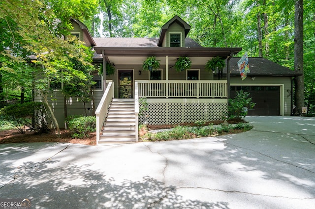 1560 Bubbling Creek Rd NE, Atlanta, GA 30319 - view of front facade featuring a porch, driveway, an attached garage, stairs, and a shingled roof