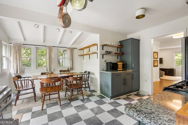 1682 Grace St SE, Atlanta, GA 30316 - kitchen with open shelves, beamed ceiling, stainless steel microwave, gray cabinets, and light floors