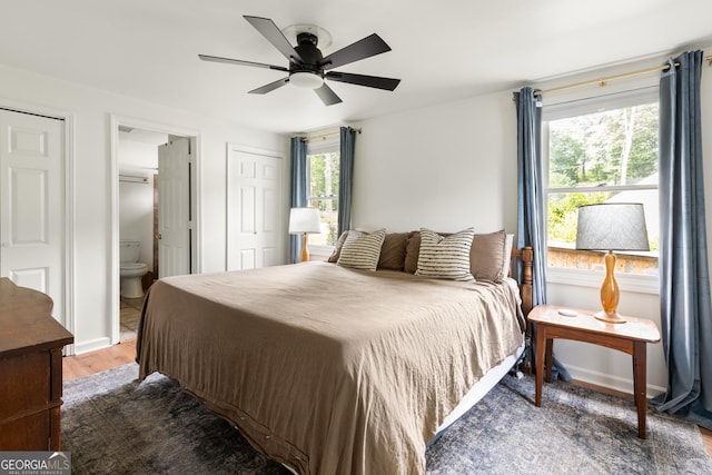 1682 Grace St SE, Atlanta, GA 30316 - bedroom with wood finished floors, baseboards, ensuite bathroom, and a ceiling fan