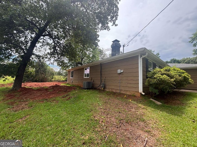 6668 Prinston Cir, Douglasville, GA 30135 - view of side of property with a chimney, cooling unit, and a yard