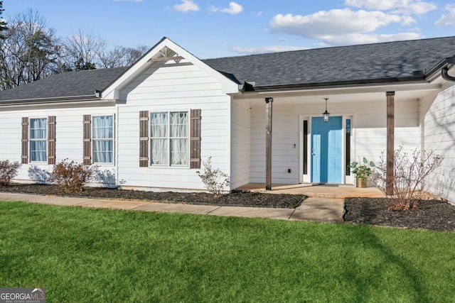 397 Harvey Lokey Rd, Bethlehem, GA 30620 - back of house with a lawn, roof with shingles, and a porch