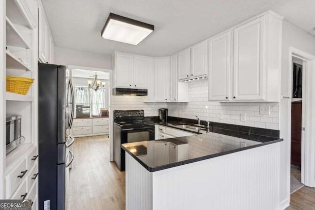 397 Harvey Lokey Rd, Bethlehem, GA 30620 - kitchen featuring stainless steel appliances, under cabinet range hood, light wood finished floors, white cabinets, and backsplash