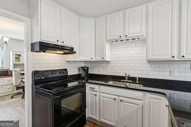397 Harvey Lokey Rd, Bethlehem, GA 30620 - kitchen featuring black range with electric stovetop, under cabinet range hood, white cabinets, and dark countertops