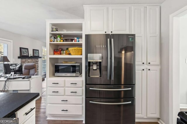 397 Harvey Lokey Rd, Bethlehem, GA 30620 - kitchen featuring refrigerator with ice dispenser, stainless steel microwave, white cabinets, dark wood-style floors, and dark countertops