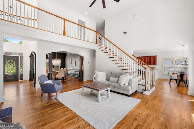 414 Dogwood Way, Canton, GA 30114 - living area with a high ceiling, stairs, a chandelier, arched walkways, and wood finished floors