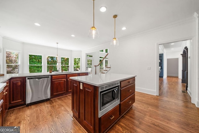 414 Dogwood Way, Canton, GA 30114 - kitchen featuring stainless steel appliances, a sink, light countertops, wood finished floors, and ornamental molding