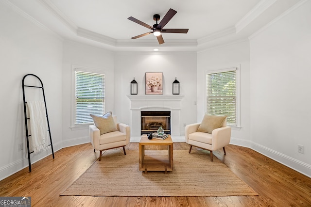 414 Dogwood Way, Canton, GA 30114 - living area featuring plenty of natural light, a raised ceiling, a fireplace, light wood-style floors, and ornamental molding